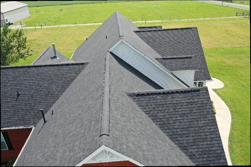 Aerial view of a gray shingle roof and its intersecting rooflines.